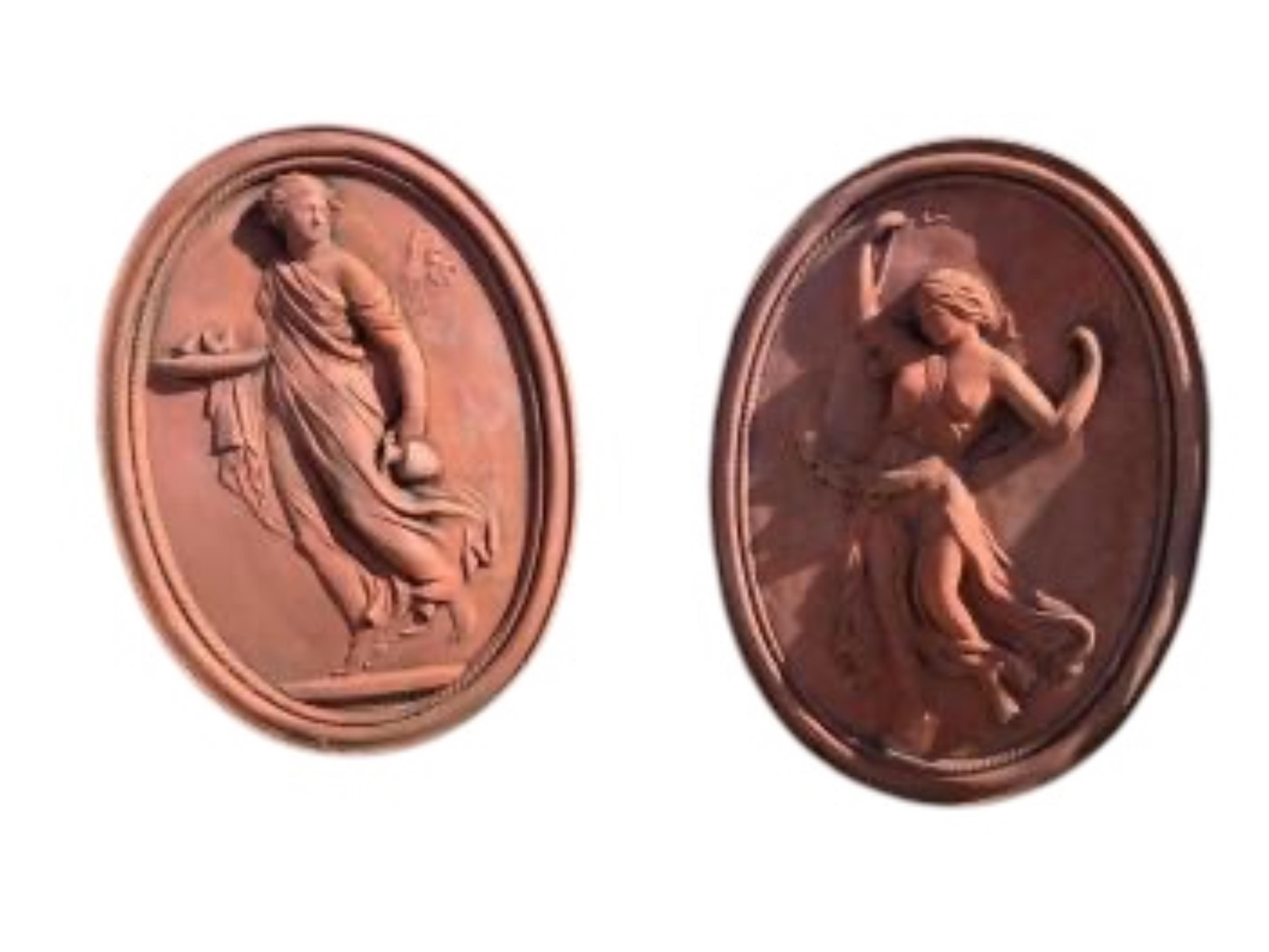 A pair of oval terracotta classical figure garden wall plaques, width 37cm, height 51cm